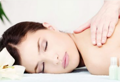 Relaxed female receiving back and shoulder massage