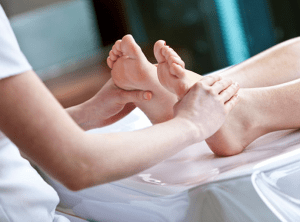 Beautician massages soles of feet during luxury spa pedicure at Lagoon Wimbledon.