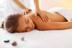 Full body massage being performed by beauty therapist on female client